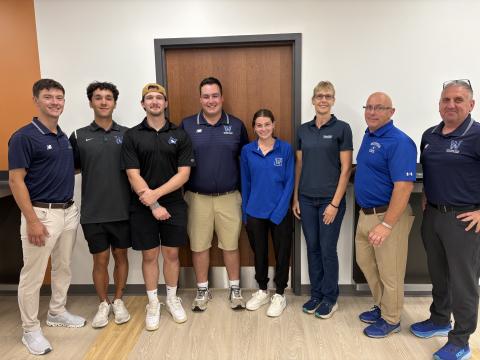 Five Westfield State students stand with three faculty and staff members from the Athletic Training program.
