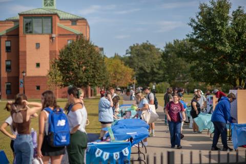 Crowd visits tables on Campus Green