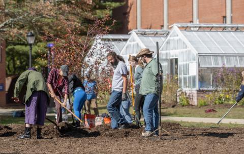 Students and faculty plant a meadow outside the Wilson Greenhouse