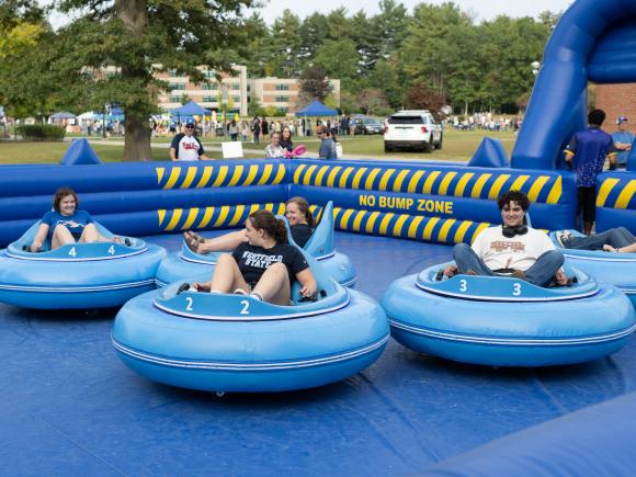 Students in blue inflatable bumper cars