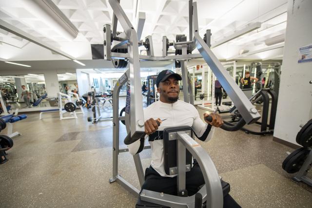 Student using exercise equipment during a workout session.