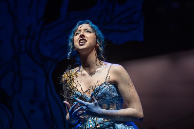 Student performing in costume for the production Into the Woods.