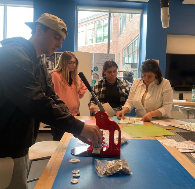 Students working on a project together for a communications course.