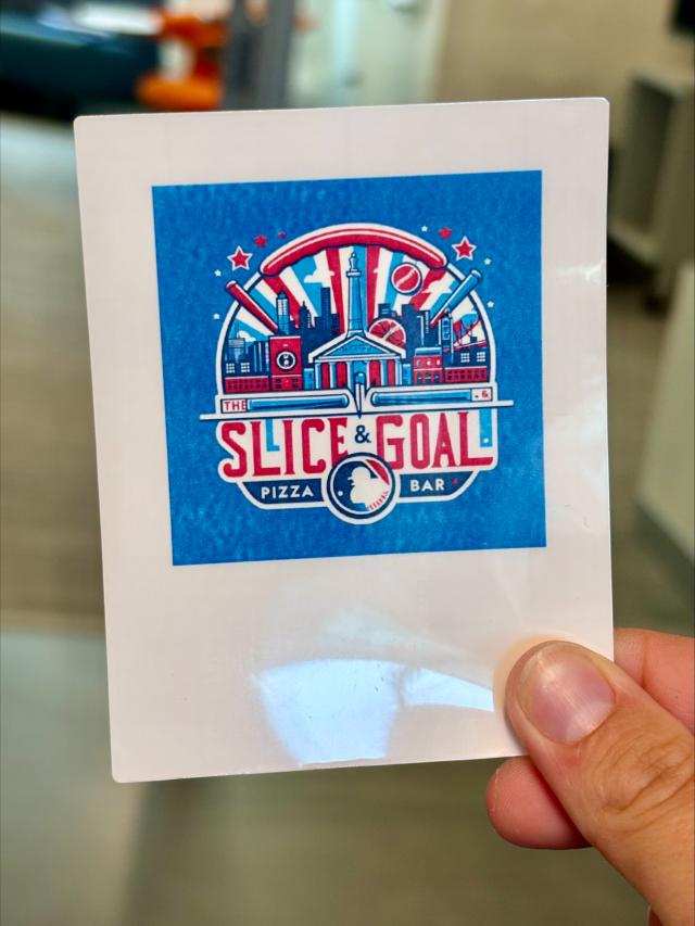 sticker with a white background, blue square, labeled "slice goal pizza cafe"; red white and blue color scheme