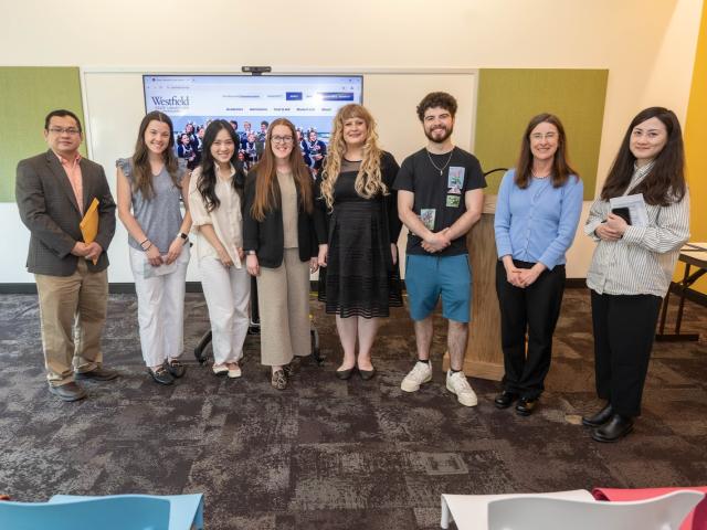 Accounting faculty and students smiling at an academic ceremony.