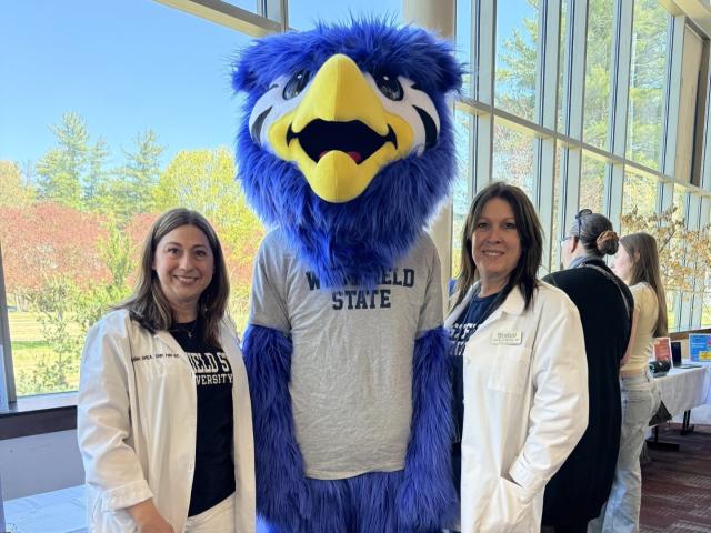 Two staff members from Health Services smiling with Nestor.