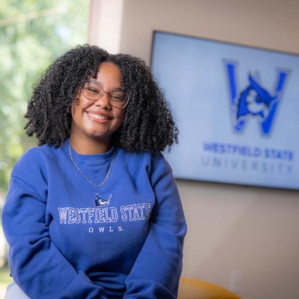 Dianyeliz Ozuna Sandoval, president of the Class of 2026. She's wearing a blue sweatshirt and poses in front of a white wall.