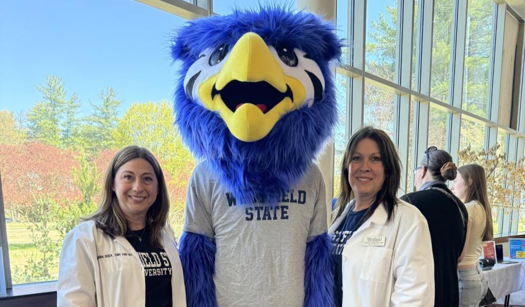 Two staff members from Health Services smiling with Nestor.