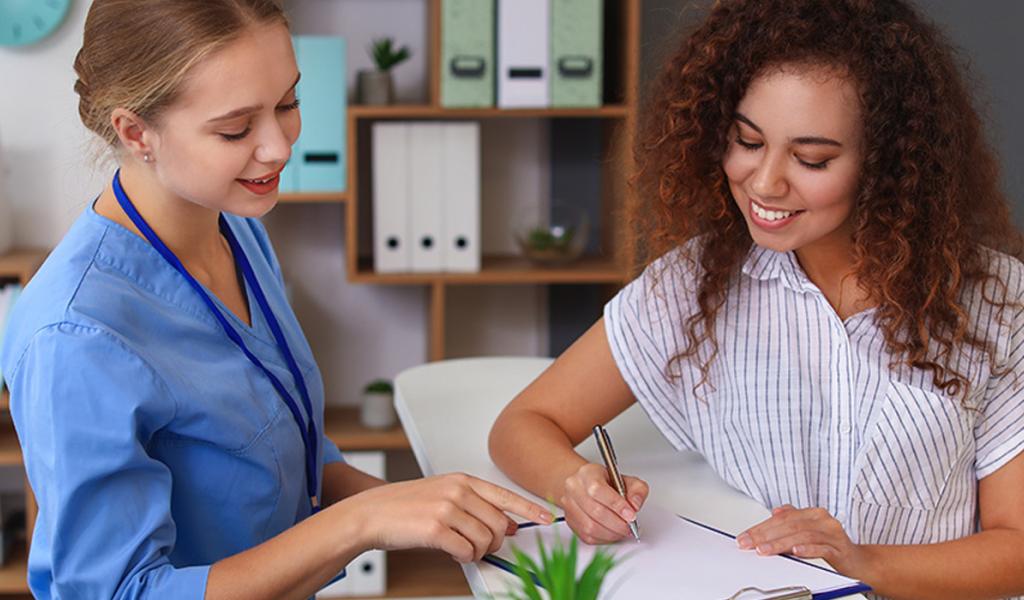 two woman reviewing paperwork