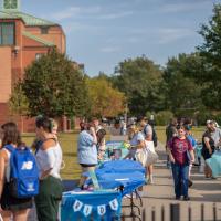 Crowd visits tables on Campus Green